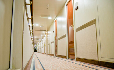 Corridor or aisle to cabins, staterooms or suites on classic cruise ship or cruiseship liner...