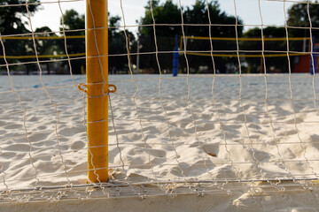 Net fence around the volleyball court, beach volleyball, sport, outdoor, playground, sand, sunny day, without people, background.