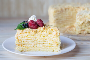 Piece of napoleon cake. Creamy vanilla slice dessert on plate. Delicious pastry served with...