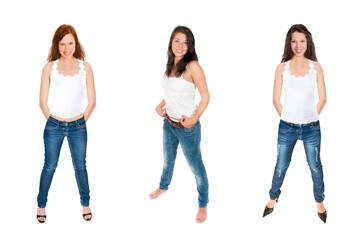 Full length portraits of three attractive young women wearing blue jeans an bright tops, isolated on white studio background