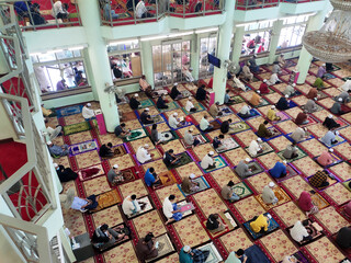 KUALA LUMPUR, MALAYSIA -AUGUST 14, 2020: The atmosphere in the mosque that practices social distancing while performing prayers during the Covid-19 pandemic. Muslim men are performing Friday prayers.