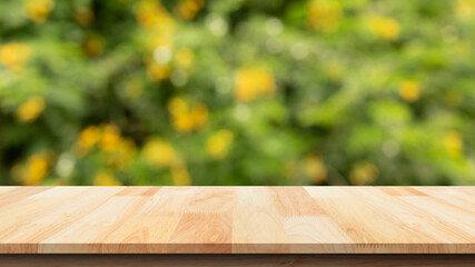 Empty wooden table isolated on bokeh green and yellow nature background. For your product placement...