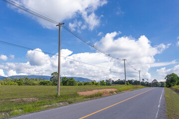Fototapeta na wymiar Empty asphalt road with electricity post on countryside