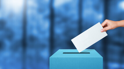 Woman hand putting voting ballot into vote box. Voting concept