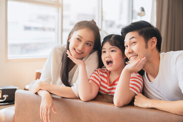 Happy Attractive Young asian Family Portrait Healthy harmony in life family day concept asian family man woman and little girl having good time together.