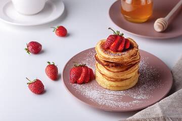 Delicious, only baked pancakes with fresh aromatic strawberries