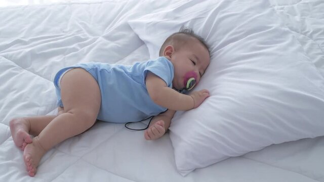 Family concept. The baby is sleeping and daydreaming in bed. 4k Resolution.