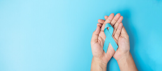 November Prostate Cancer Awareness month, Man holding light Blue Ribbon for supporting people...