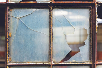 Old cracked and Broken Window in an industrial factory.