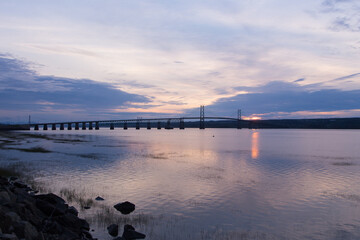 Obraz premium The 1935 Island of Orleans Bridge over the St. Lawrence River seen in silhouette at dawn, Quebec City, Quebec, Canada