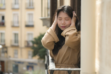 dramatic portrait of young beautiful sad and depressed Asian Japanese woman feeling unhappy and worried suffering some problem going through depression