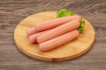 Tasty meat sausages over board