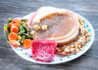Turkey cranberries and vegetables in a frozen state on a plate