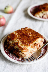 Apple and Cheese Cobbler Crisp. Cobbler or Crumble dessert with apples on plates on beige linen table. Selective focus