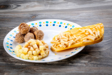 TV dinner of macaroni and meatballs removed and, on a plate,