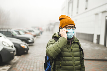 A man wearing a mask on the street. Protection against virus and grip