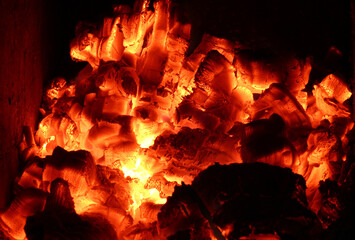 hot coals burning down in a stone oven