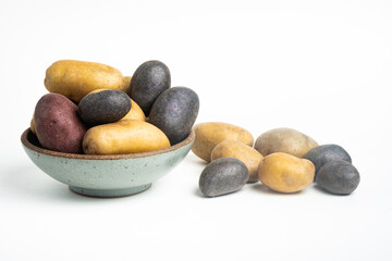Assorted Color Potatoes On Bowl And Table