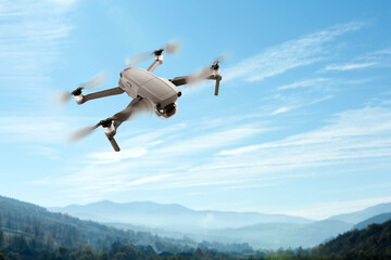 Fototapeta na wymiar Modern drone flying over picturesque mountains. Aerial survey