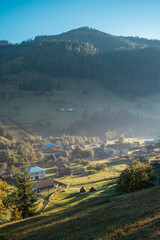Beautiful Mountain village in Ukraine with forest and valleys at sunset. Nature landscape beautiful hills.