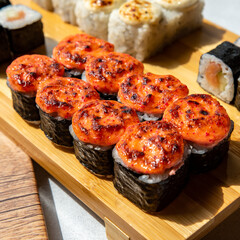 sushi set and sushi roll on wooden board
