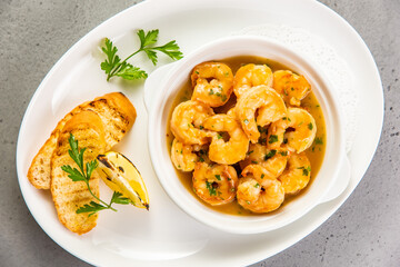 Shrimp stir fry in a wok with serving plates in the background