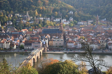 Fototapeta na wymiar Aerial view of Heidelberg old town with Church of the Holy Spirit and Old Bridge over the river Neckar during sunset in autumn in Heidelberg, Germany