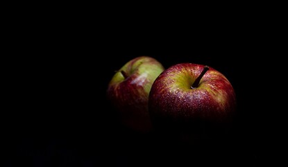 two isolated fresh apples on black background