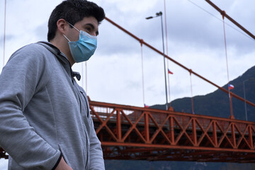 young man wearing mask standing in the city streets
