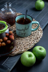 Tea set on a wooden table, on a dark background.
