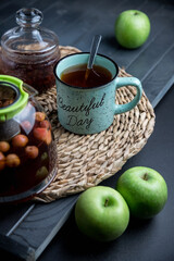 Tea set on a wooden table, on a dark background.