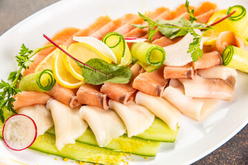 Raw perched fish fillet at the fish market with price tags. Large assortment of fresh chilled seafood, perched fish fillet, salmon. Keto food and healthy nutrition concept.