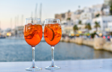 two drinks in front of a mediterranean harbor