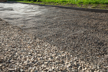 Road surface construction and stabilization using a geogrid.