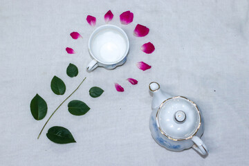 empty tea and saucer with rose petals