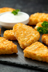 Hash brown potato patties on rustic stone board
