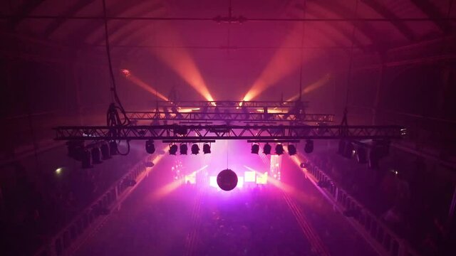 Club venue with flashing purple lights during a trance party. pan up. Paradiso, Amsterdam