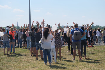 Group of aircraft fans gathered at airport festival and cheering up