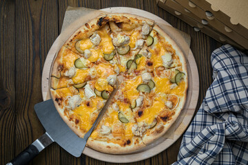 Pizza, in stock. on a brown wooden table.
