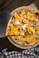 Pizza, in stock. on a brown wooden table.
