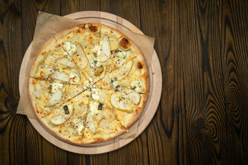 Pizza, in stock. on a brown wooden table.
