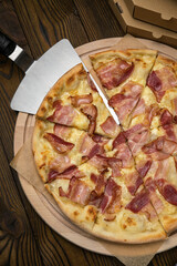 Pizza, in stock. on a brown wooden table.
