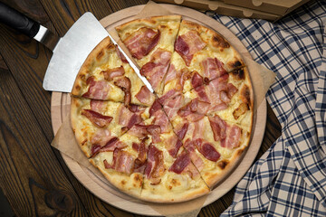 Pizza, in stock. on a brown wooden table.

