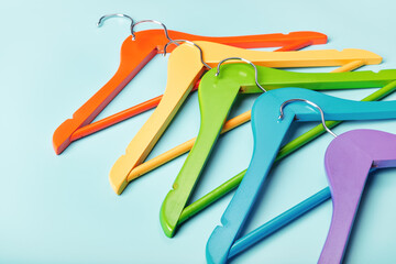 Multi-colored clothes hangers on a blue background. Concept of shopping and sale.