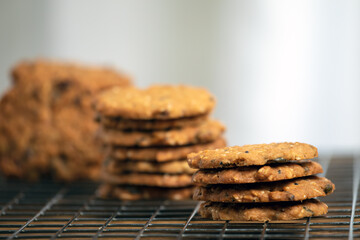 Homemade delicious whole grains cookies stacked and row on stainless griddle