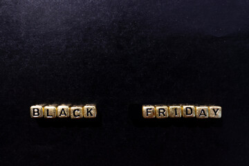 Black Friday sale concept. friday november gold text on black background. Copy space, close-up, top view, flat lay.