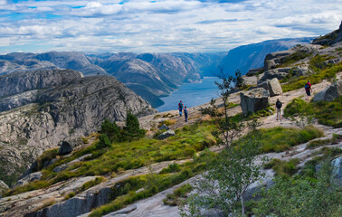 Fototapeta na wymiar Hiking trail to Preikestolen Mountain top with tourist near Stavanger Norway