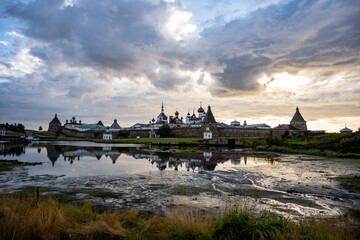 an ancient stone fortress on an island with towers and ancient temples