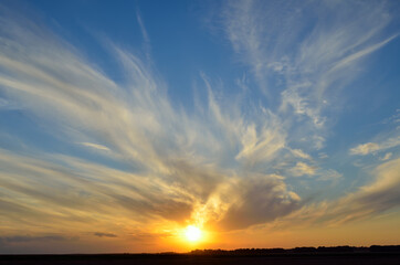 Golden rays of sunset, among the clouds in the sky