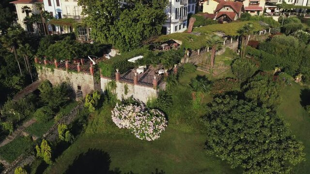 Aerial Drone Shot Tracking In To A Beautiful View of a Amazing Restaurant In The town Of Ranco On Lake Maggiore In Italy On A Calm Summers Day